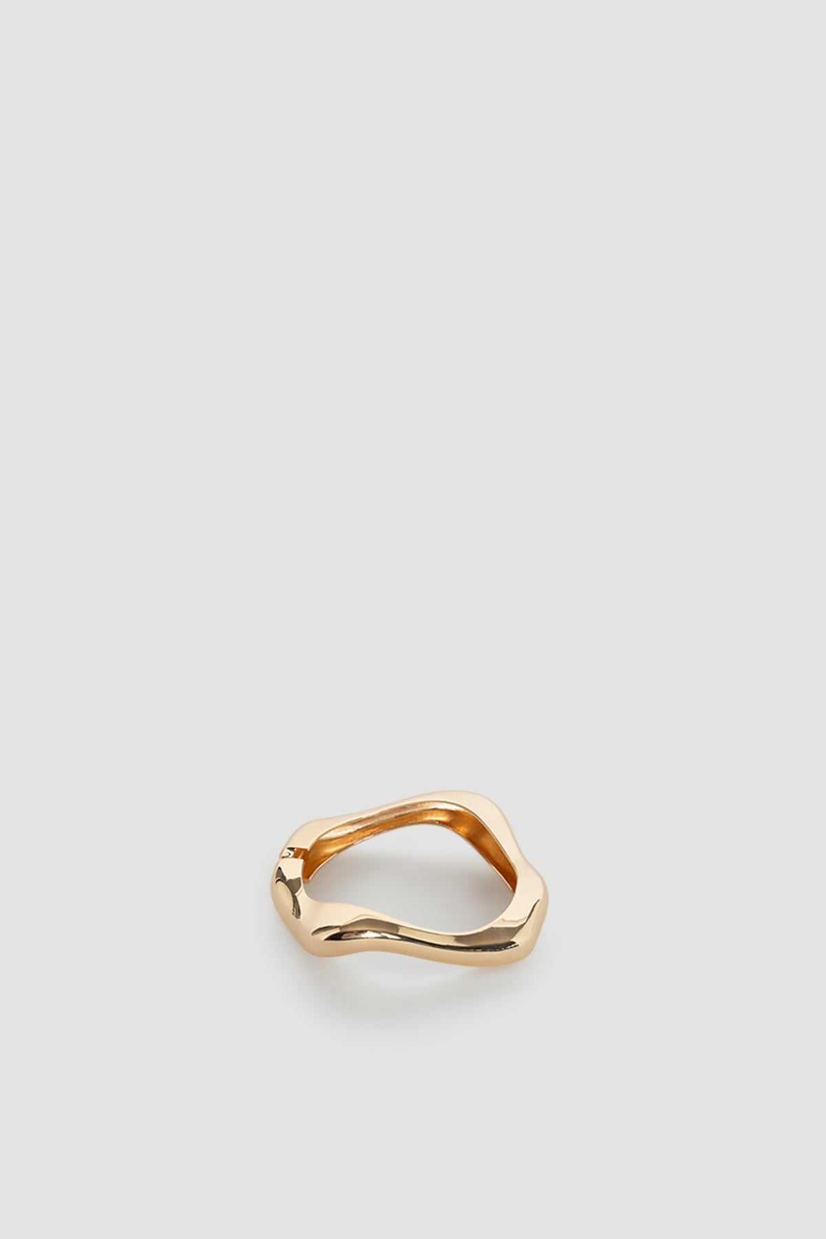 Ella Wavy Bracelet in polished gold tone with a smooth, flowing silhouette for a modern and elegant look.