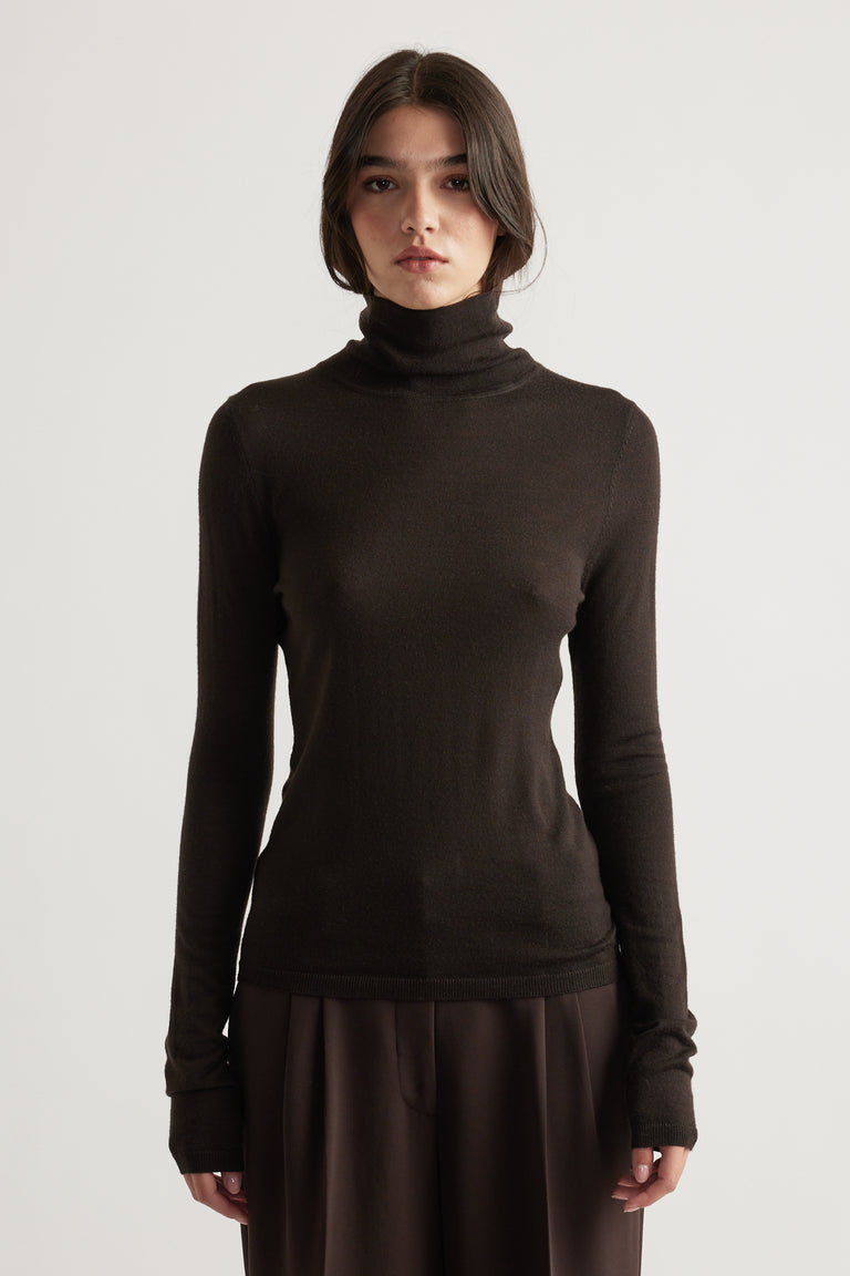 Slim-fit dark brown fine wool knit top with high neck and long sleeves for a sleek, cozy layering piece.