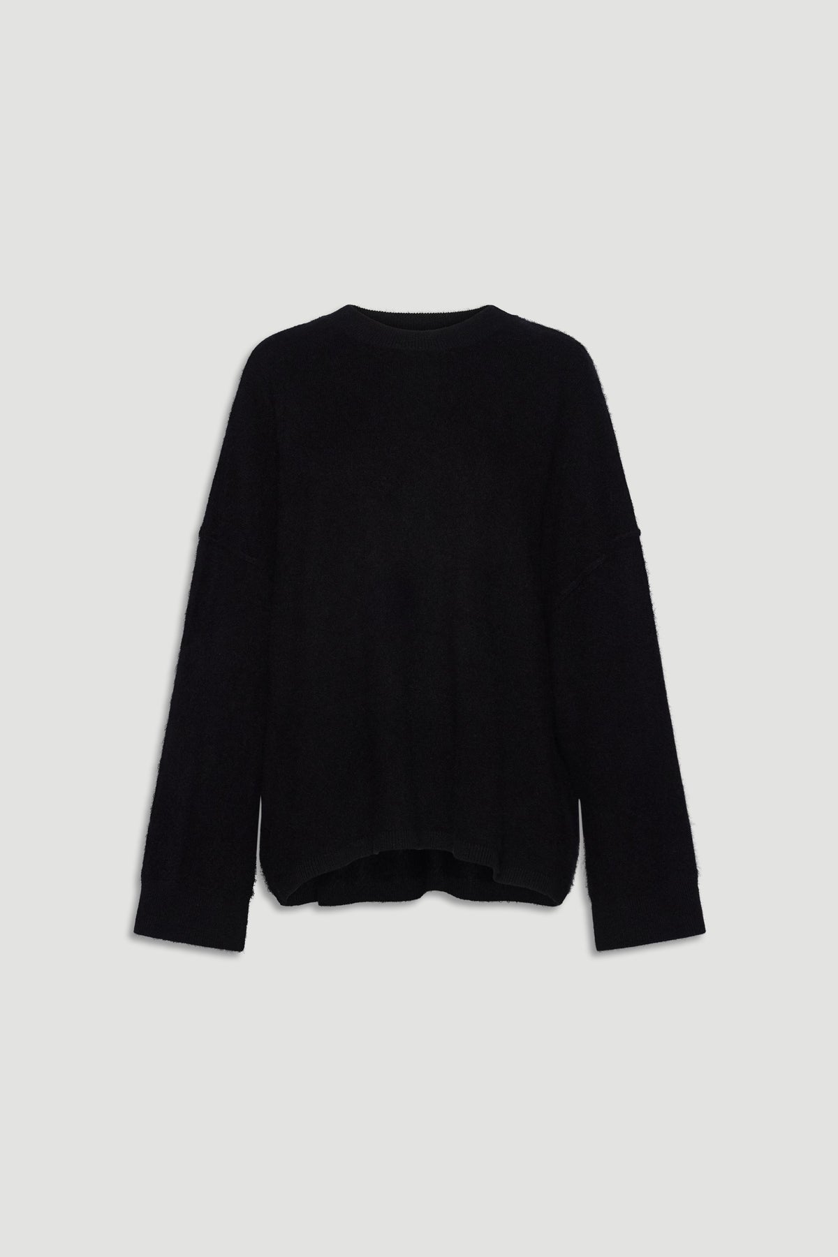 Black oversized wool knit sweater with relaxed fit and long sleeves for cozy, stylish layering.