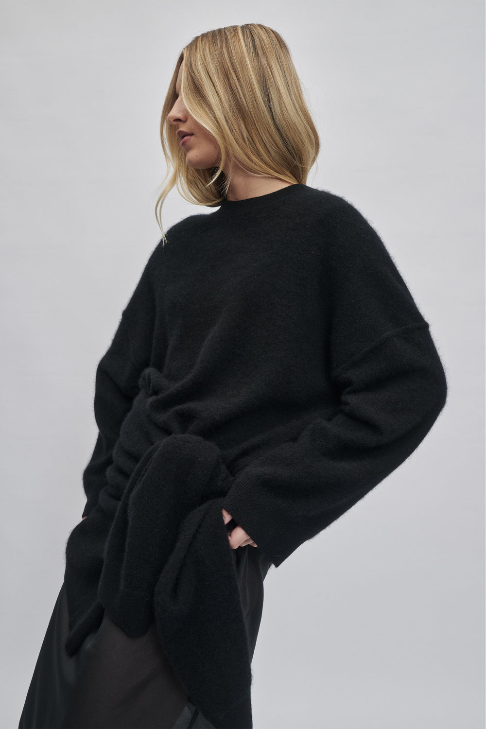 Woman wearing a soft black oversized wool knit with a relaxed fit and long sleeves for cozy everyday wear