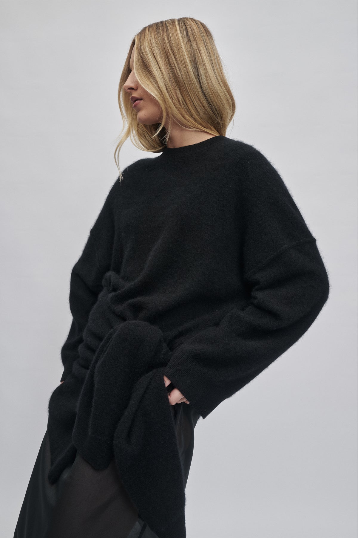 Woman wearing a soft black oversized wool knit with a relaxed fit and long sleeves for cozy everyday wear