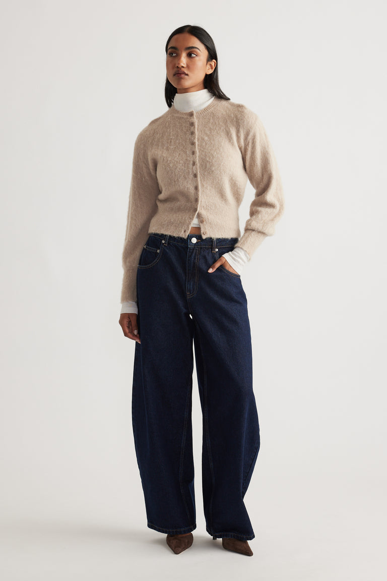 Ariel Button Through Cardigan in soft beige knit with subtle texture, button front, and long sleeves styled over a white top.