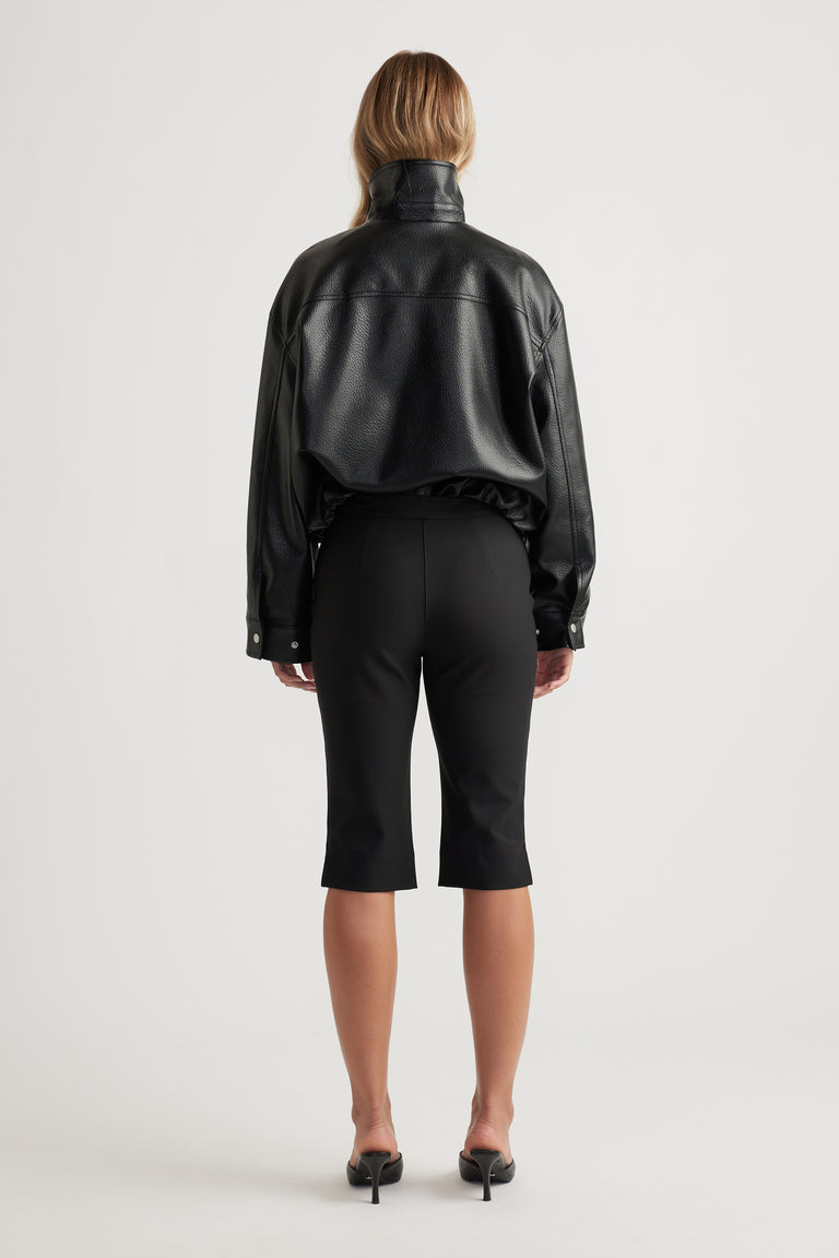 Back view of woman wearing Melanie Capri Pant in black with tailored fit by Decjuba Australian fashion brand