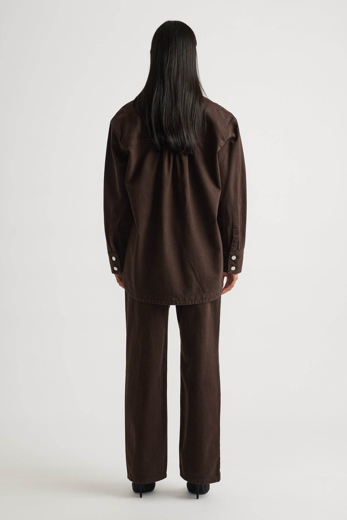 Ariana Denim Shirt in dark brown with relaxed fit and button cuffs styled with matching pants by DECJUBA Australian brand