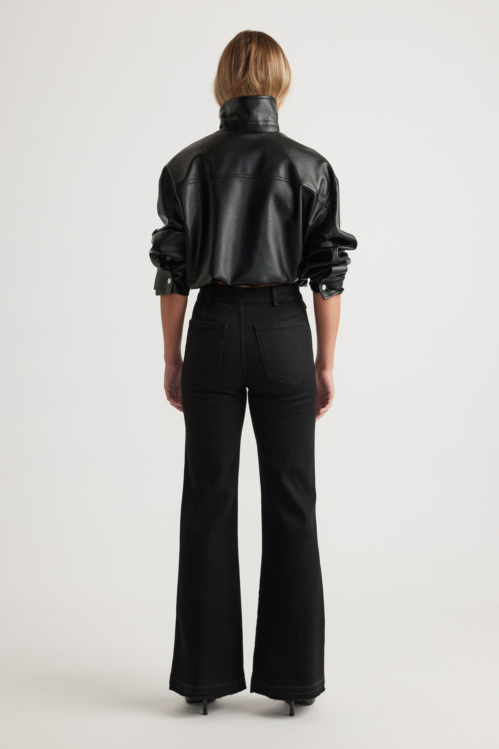 Bea Flare Jean in black denim with high waist and wide leg silhouette styled with a black leather jacket by DECJUBA Australian brand