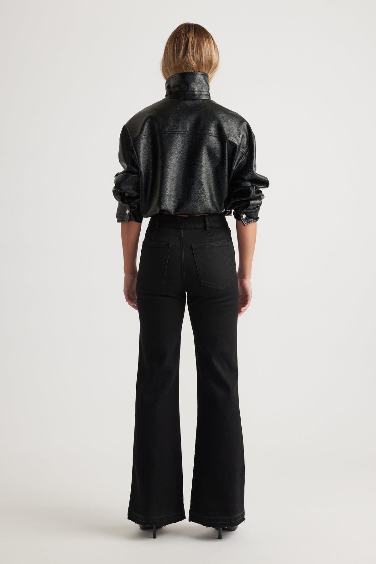 Bea Flare Jean in black denim with high waist and wide leg silhouette styled with a black leather jacket by DECJUBA Australian brand