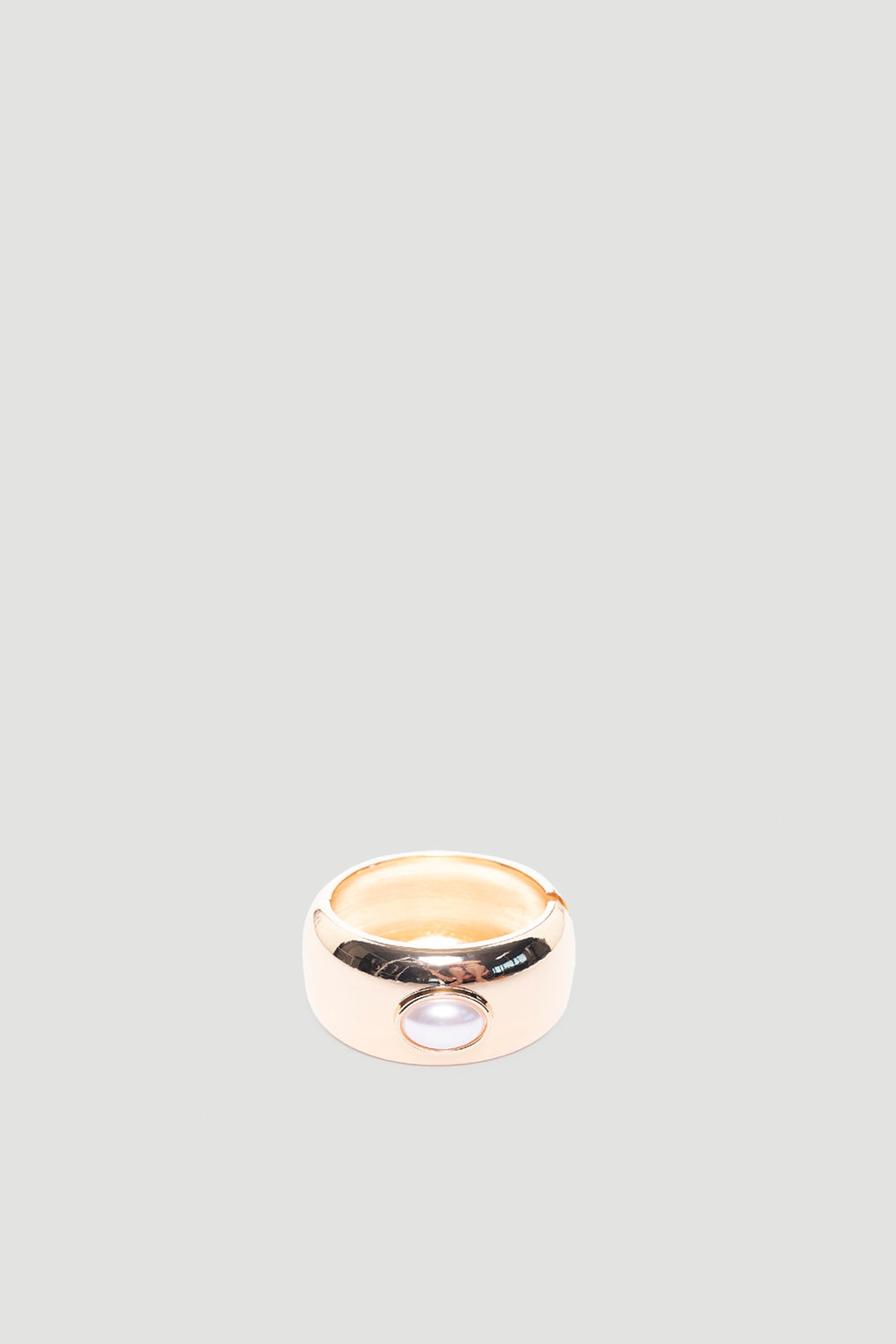 Monica Stone Cuff Bracelet in polished gold tone with single pearl detail for a refined, versatile accessory by DECJUBA