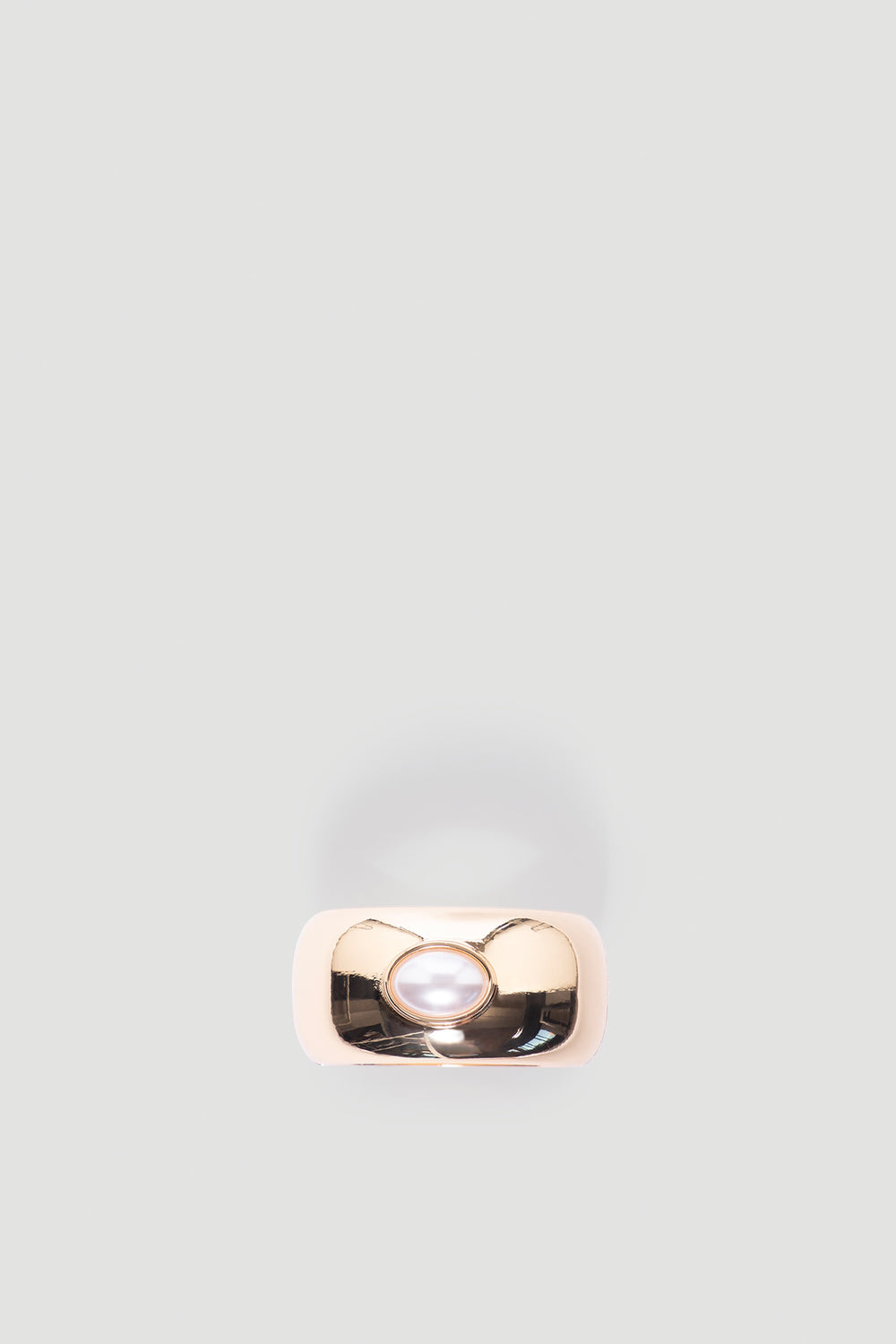 Monica Stone Cuff Bracelet in polished gold tone featuring a central pearl detail for a timeless, elegant accessory by DECJUBA