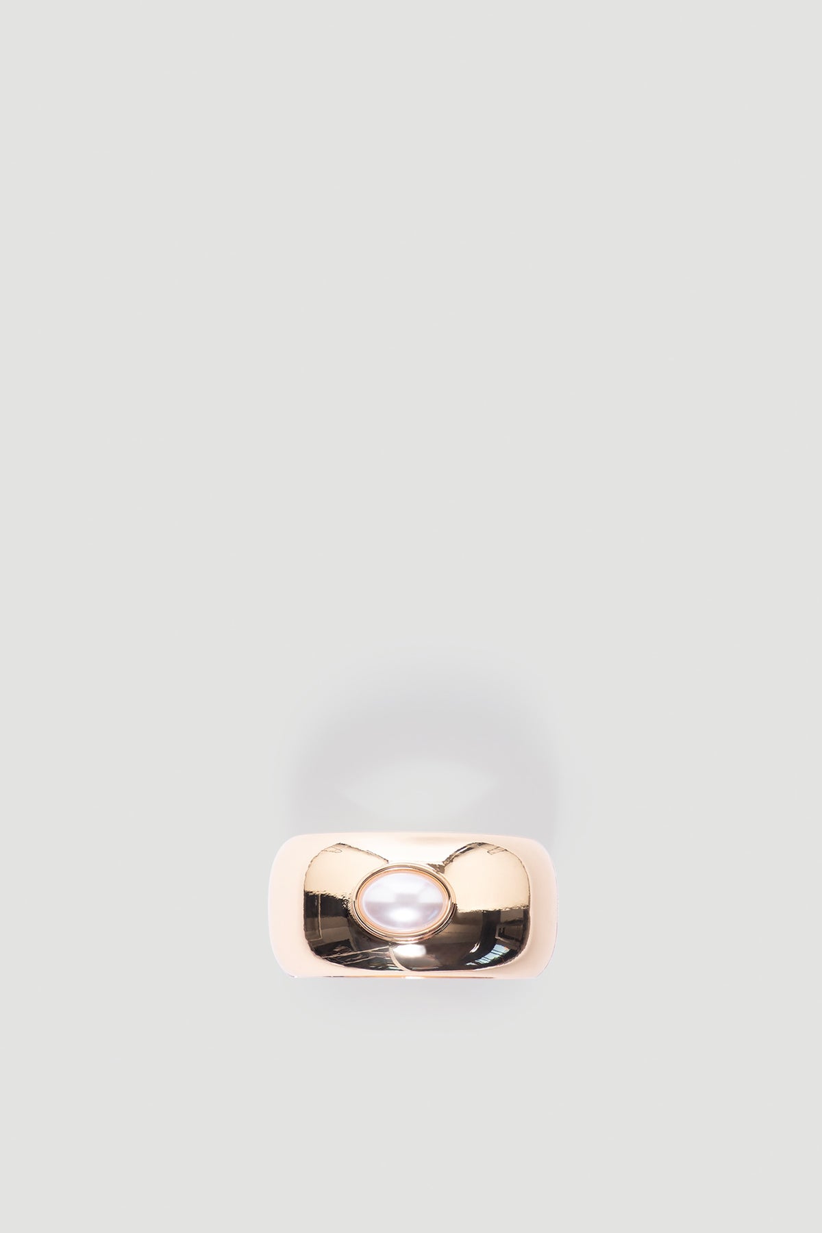 Monica Stone Cuff Bracelet in polished gold tone featuring a central pearl detail for a timeless, elegant accessory by DECJUBA