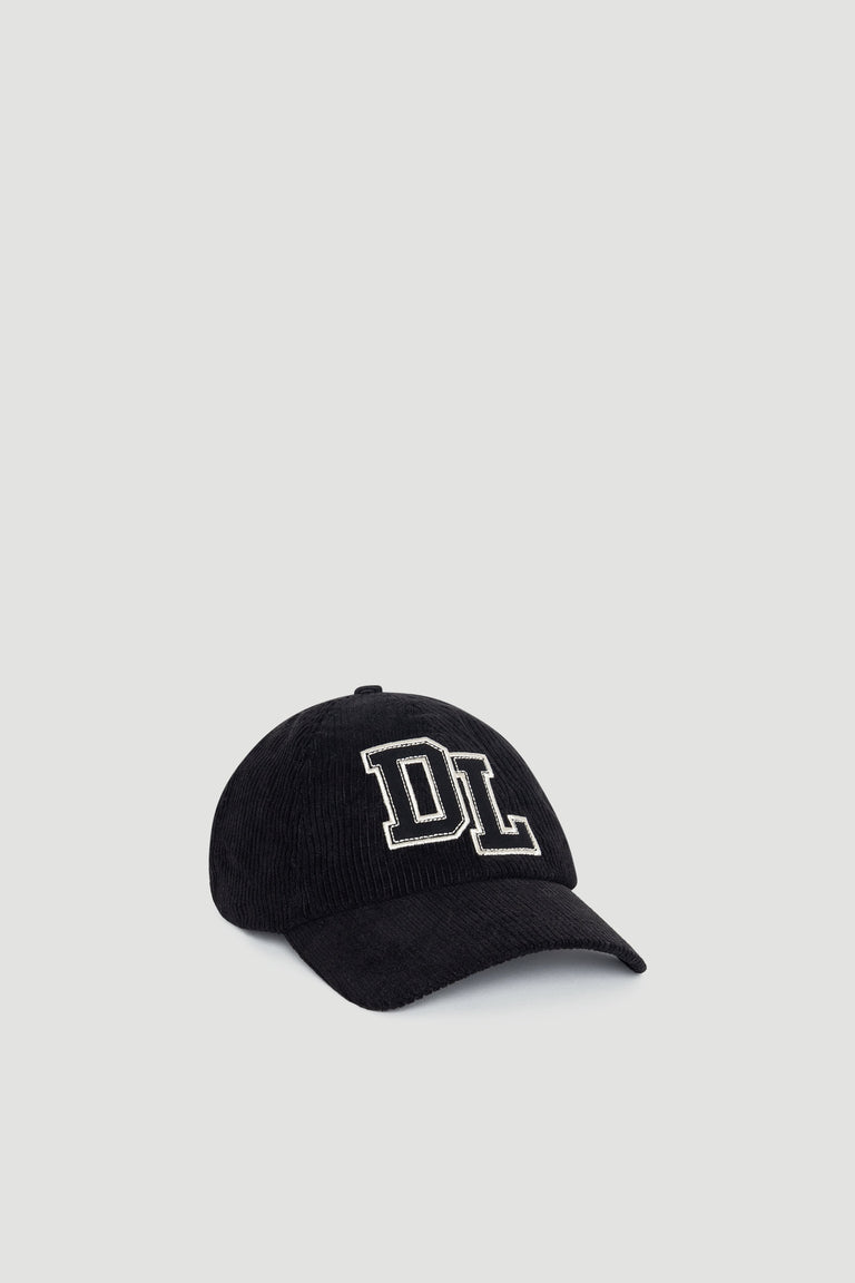 Black corduroy D-luxe Kim Cord Cap featuring bold white DL embroidery for a stylish, casual look with versatile appeal.