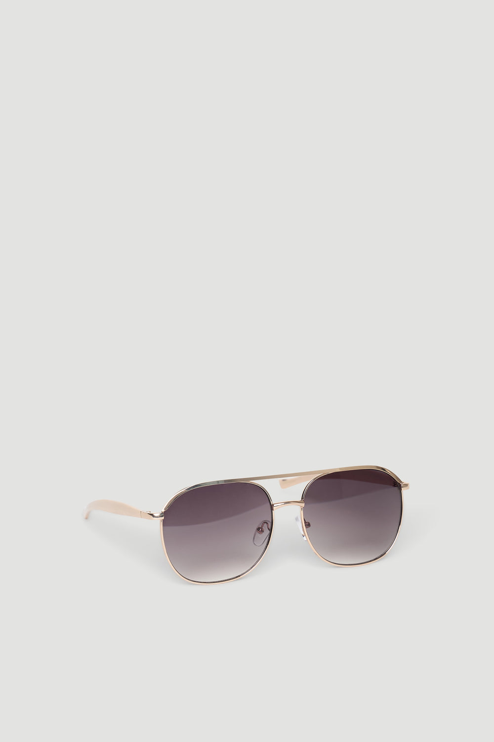 Sleek aviator sunglasses with gradient dark lenses and slim gold-tone metal frames for a timeless look.