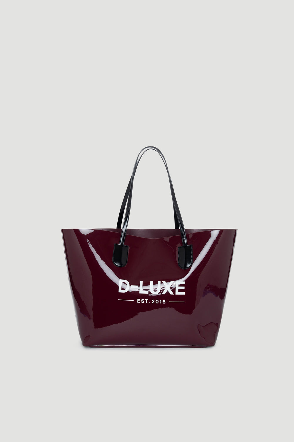 Glossy plum-colored tote bag with black handles and contrasting white branding on front panel.