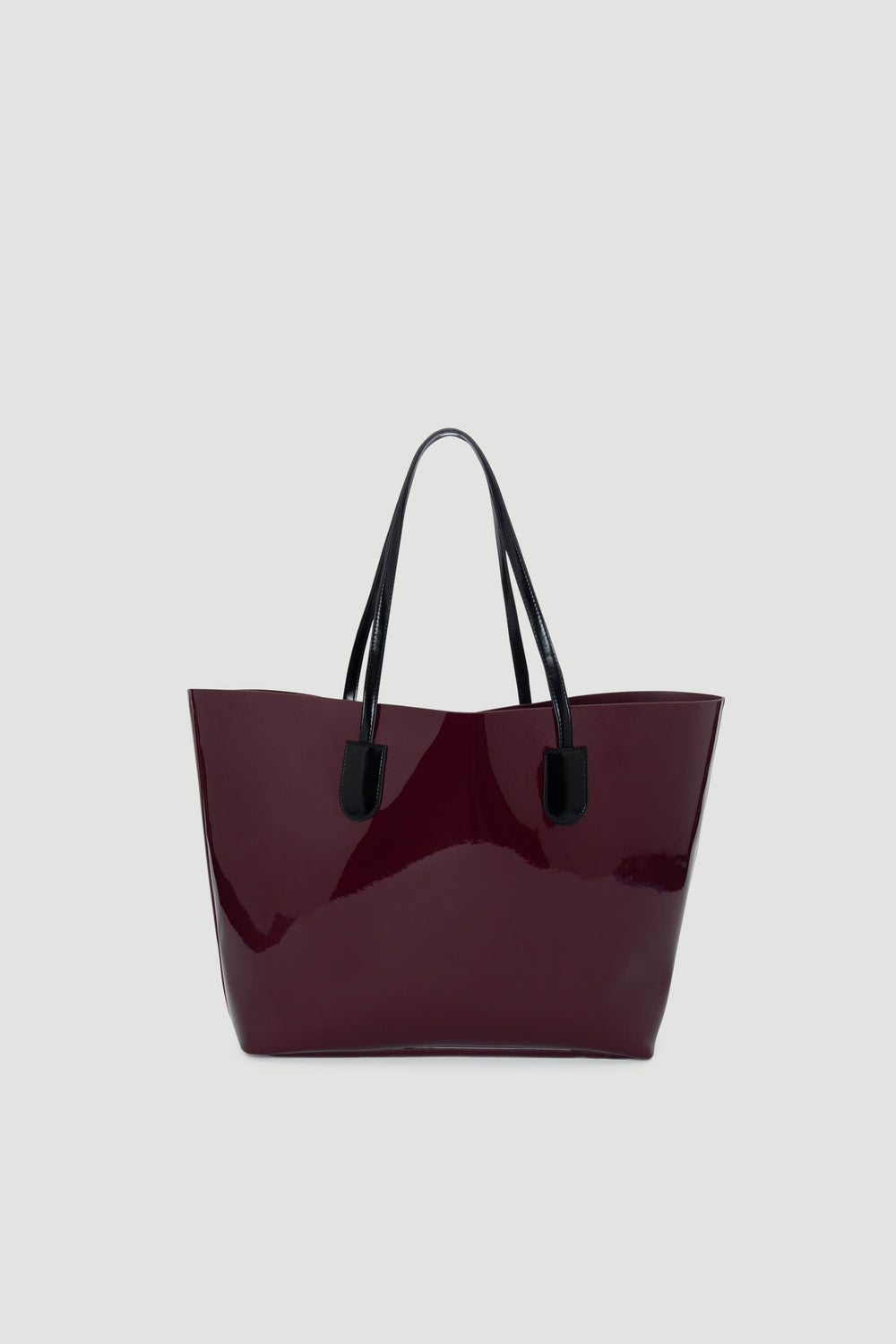 Glossy plum tote bag with black handles, featuring a sleek, structured silhouette for everyday style.