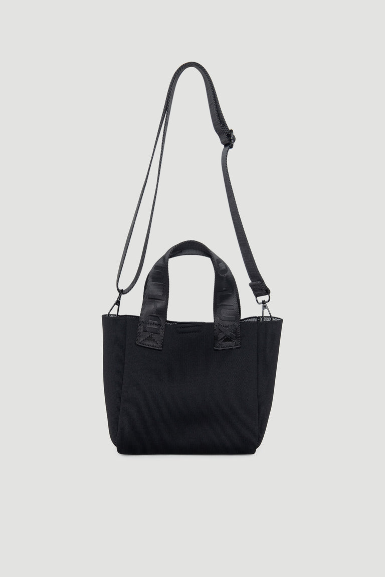 Compact black mini tote bag with dual handles and adjustable shoulder strap for versatile wear
