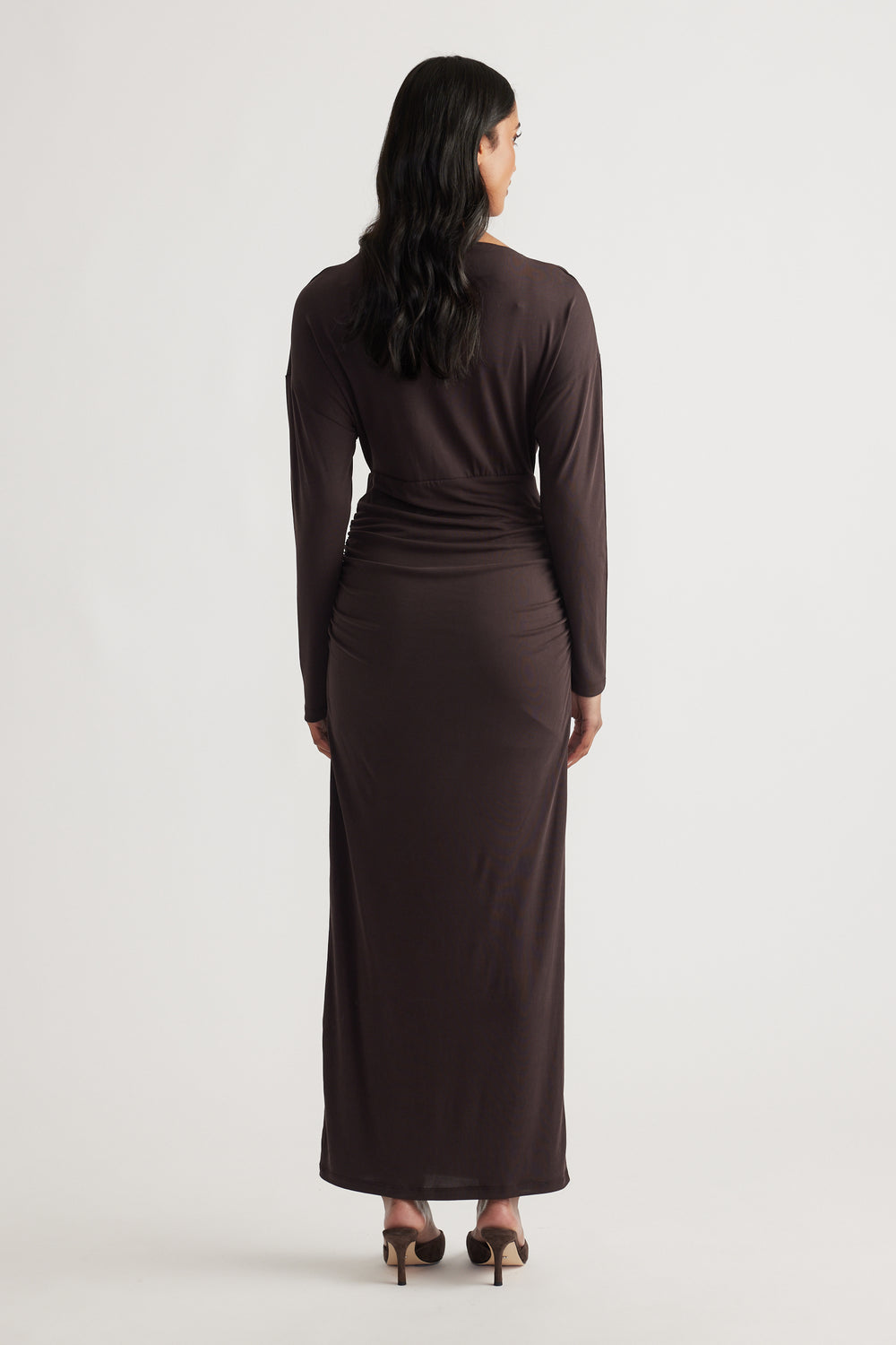 Woman seen from behind wearing Tahlia Cinched Maxi Dress in rich cedar brown with long sleeves and gathered waist detailing