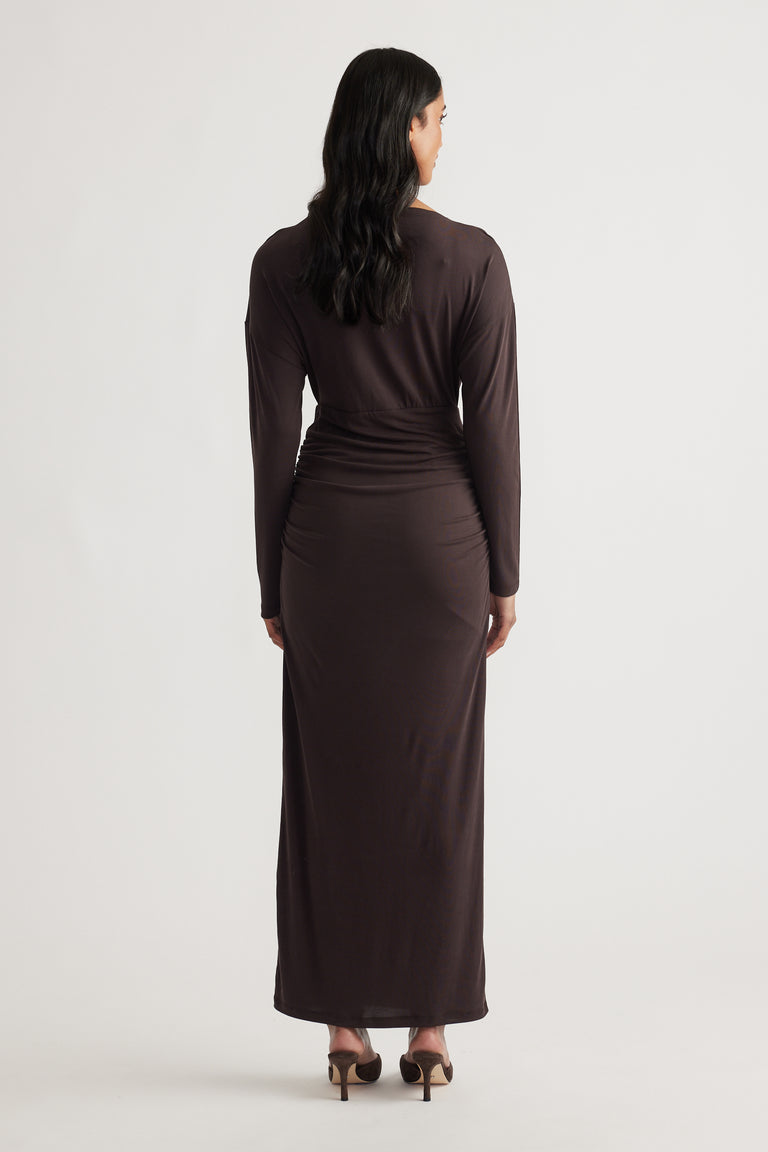 Woman seen from behind wearing Tahlia Cinched Maxi Dress in rich cedar brown with long sleeves and gathered waist detailing