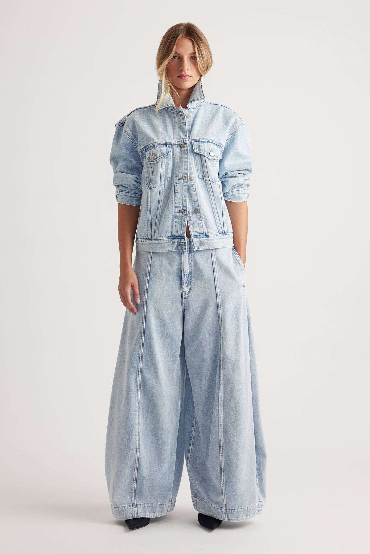 Nakita Denim Jacket in light blue wash with high collar and relaxed fit styled with wide-leg denim pants by DECJUBA Australian brand