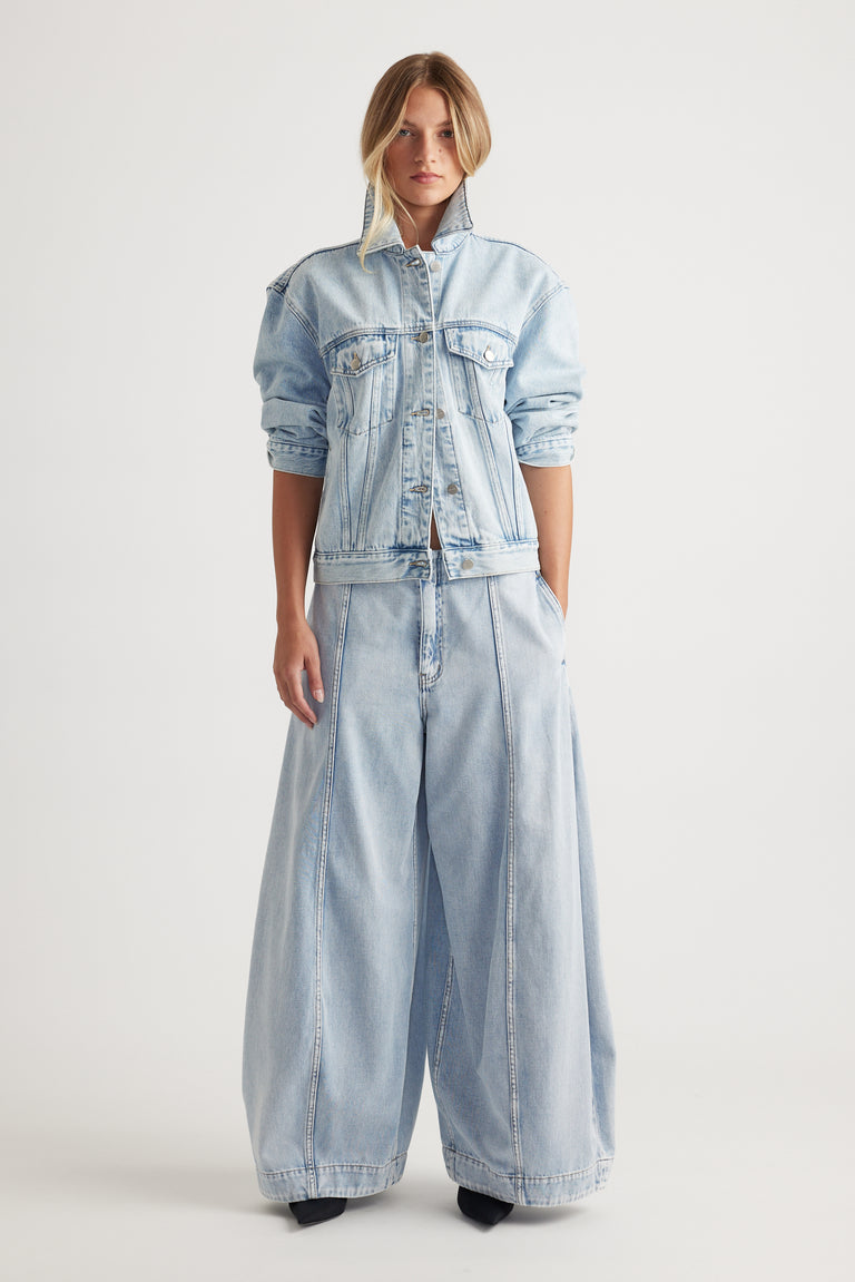 Nakita Denim Jacket in light blue wash with high collar and relaxed fit styled with wide-leg denim pants by DECJUBA Australian brand
