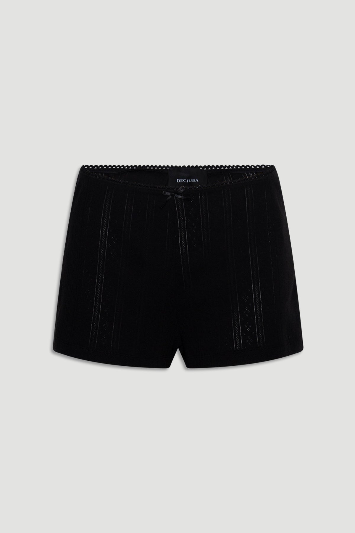 Black sleep shorts featuring delicate pointelle knit stripes, a small front bow, and scalloped waistband trim for a soft fit