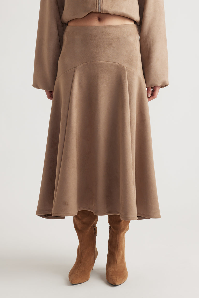Soft taupe faux suede midi skirt with a flared silhouette paired with matching long sleeves and tan suede boots