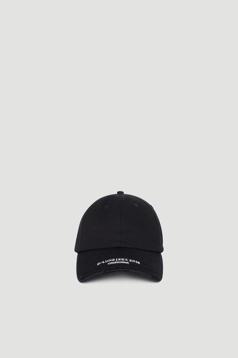 Black baseball cap with subtle distressed details and embroidered branding on the curved brim
