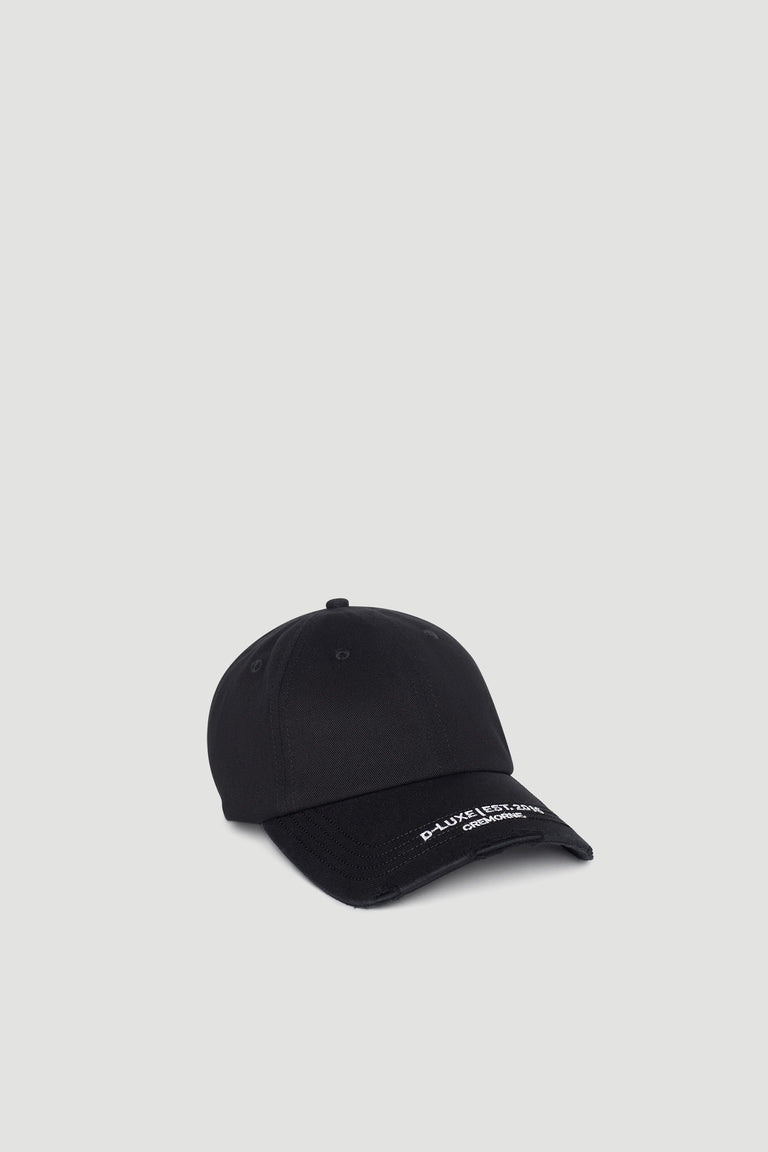 Black distressed cap with curved brim featuring subtle white embroidered logo detail on front edge