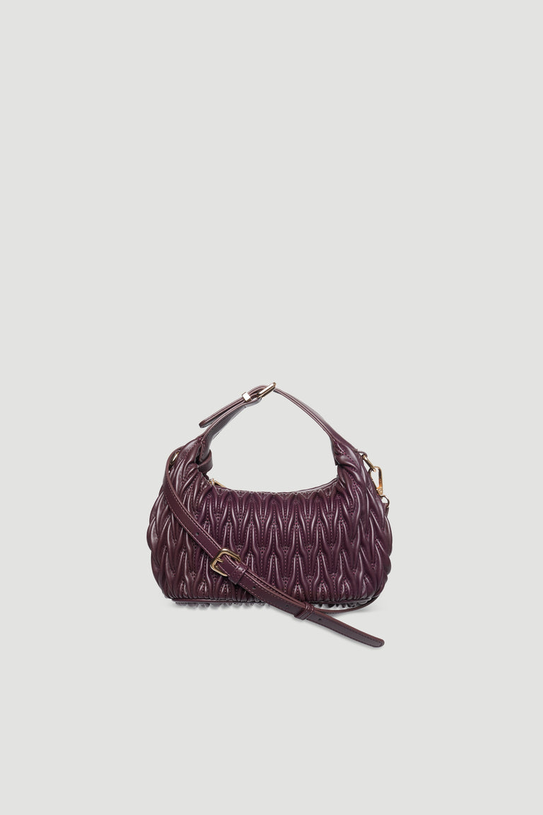 Mini padded deep purple hand bag with buckle detail, adjustable strap, and gold hardware against plain background
