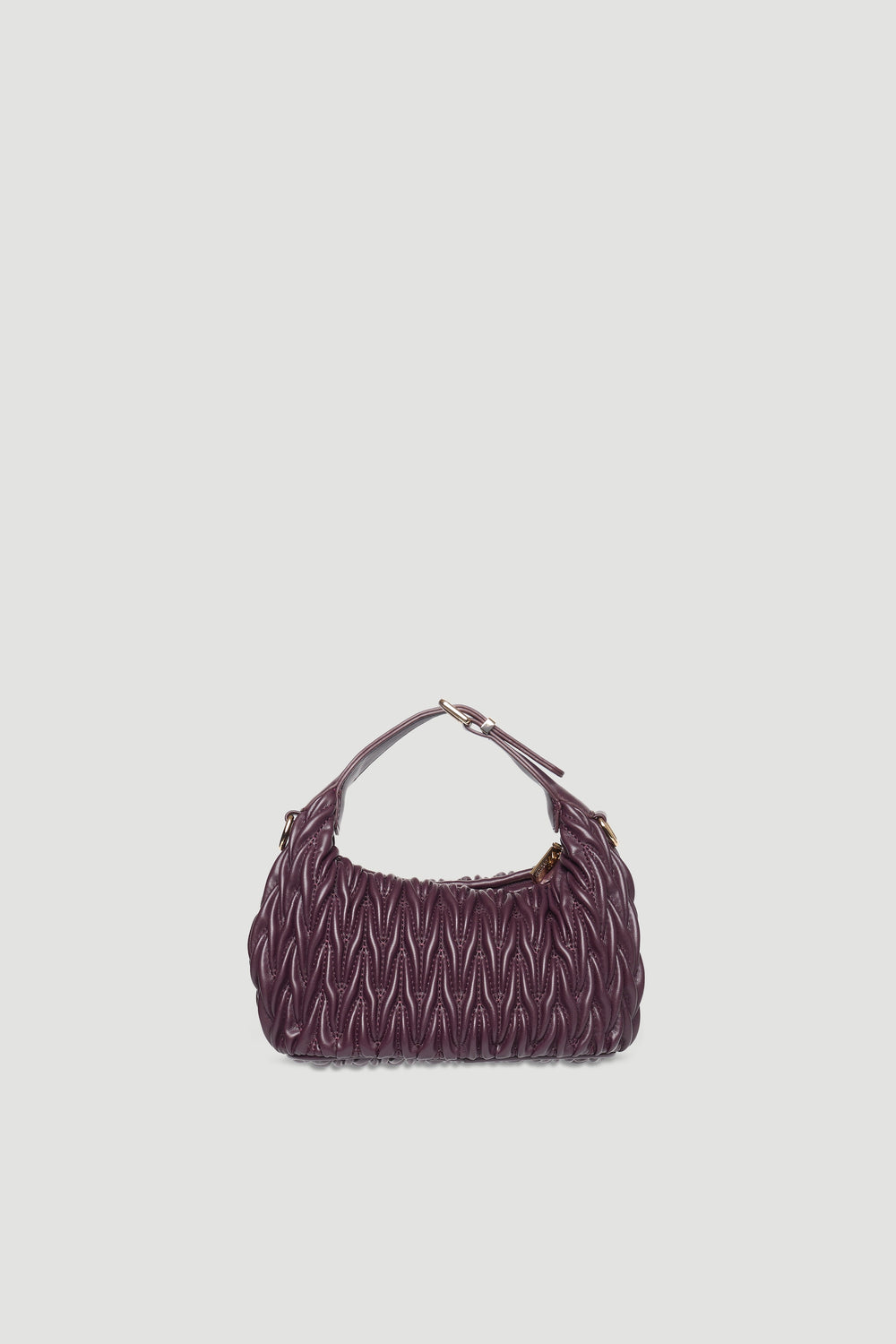 Textured deep purple mini padded handbag with buckle detail and single handle against plain light background