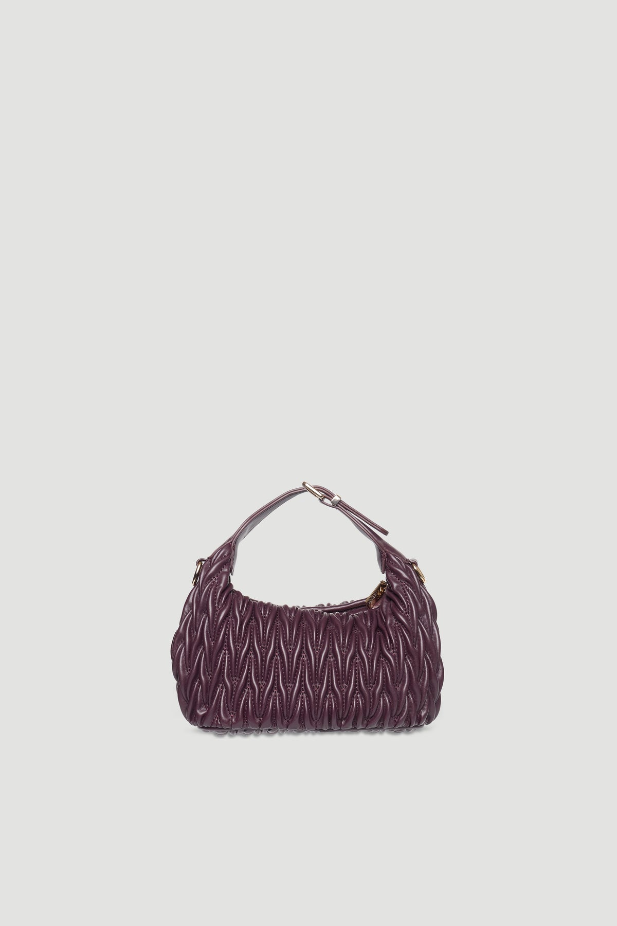 Textured deep purple mini padded handbag with buckle detail and single handle against plain light background