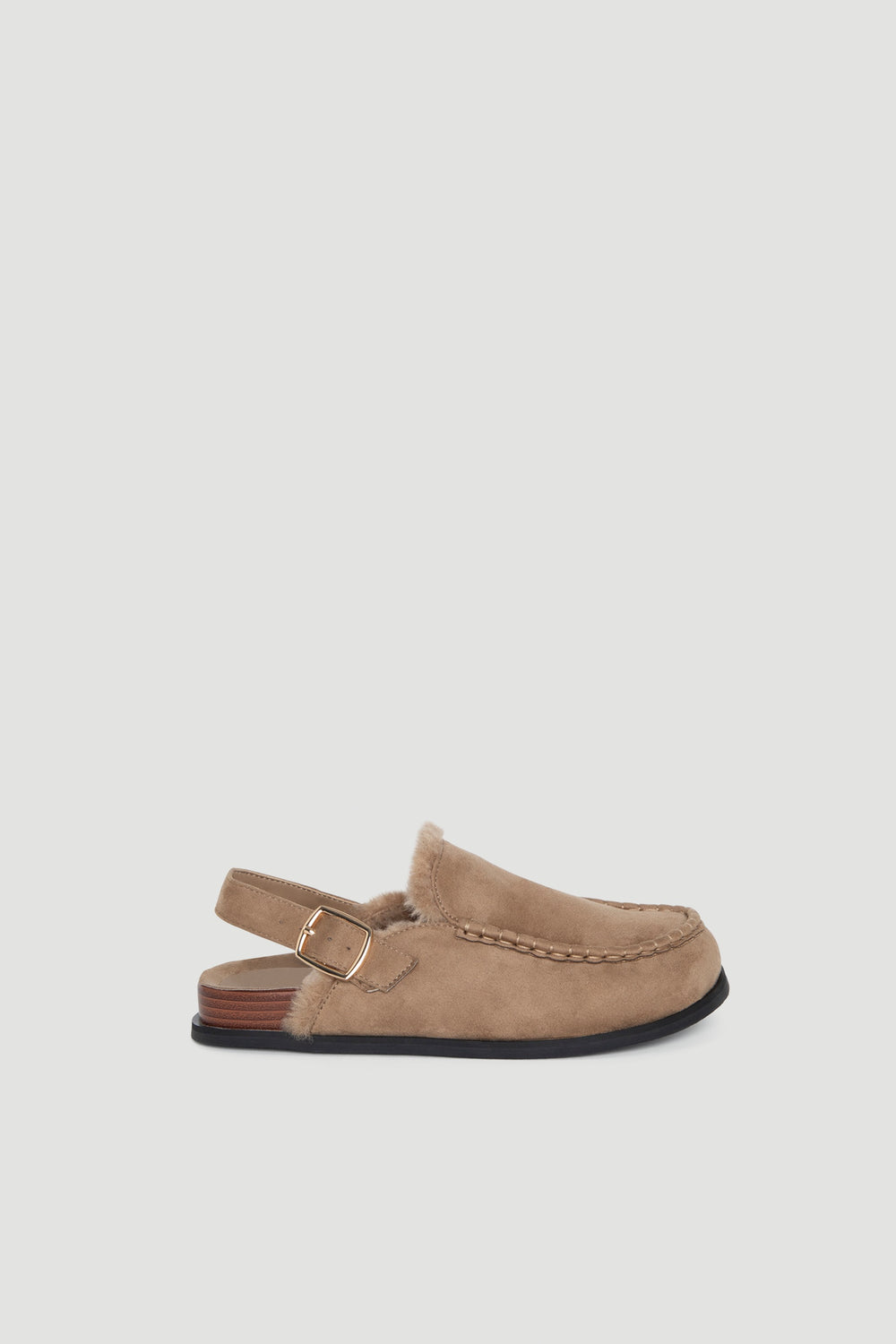 Camel suede sling back shoe with stitched detailing, soft lining, and adjustable gold buckle strap on low heel.