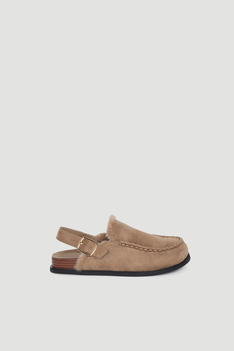 Camel suede sling back shoe with stitched detailing, soft lining, and adjustable gold buckle strap on low heel.