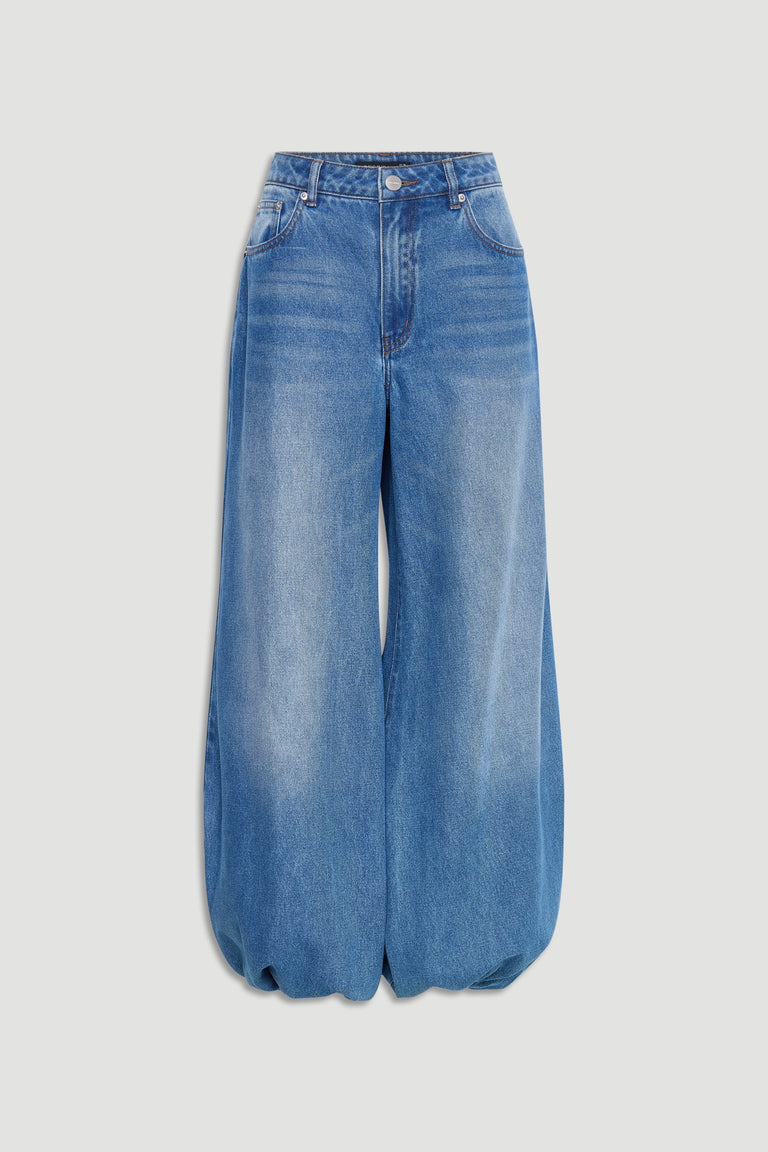 Light blue high-rise denim jeans with a balloon leg silhouette and front pockets, styled for casual wear.