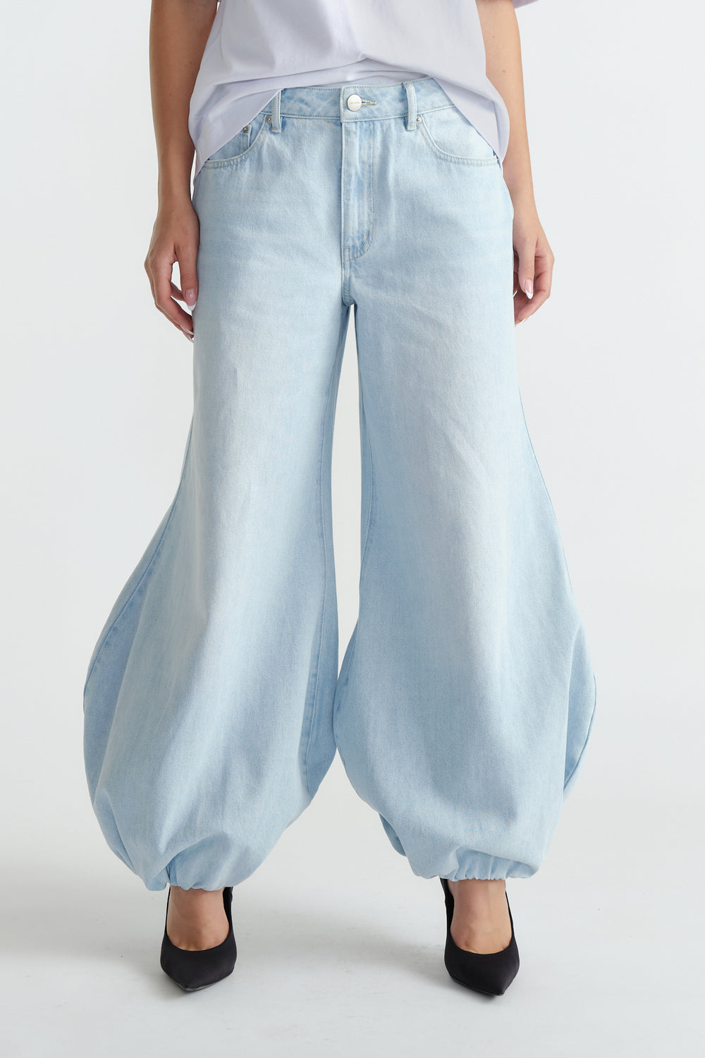 Light wash high-rise balloon jeans with a loose, tapered fit cinched at the ankles for a stylish statement look.