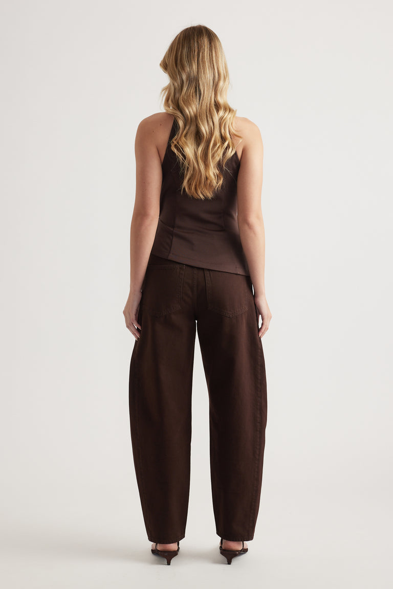 Back view of woman in a brown halter top with matching wide leg pants and heels