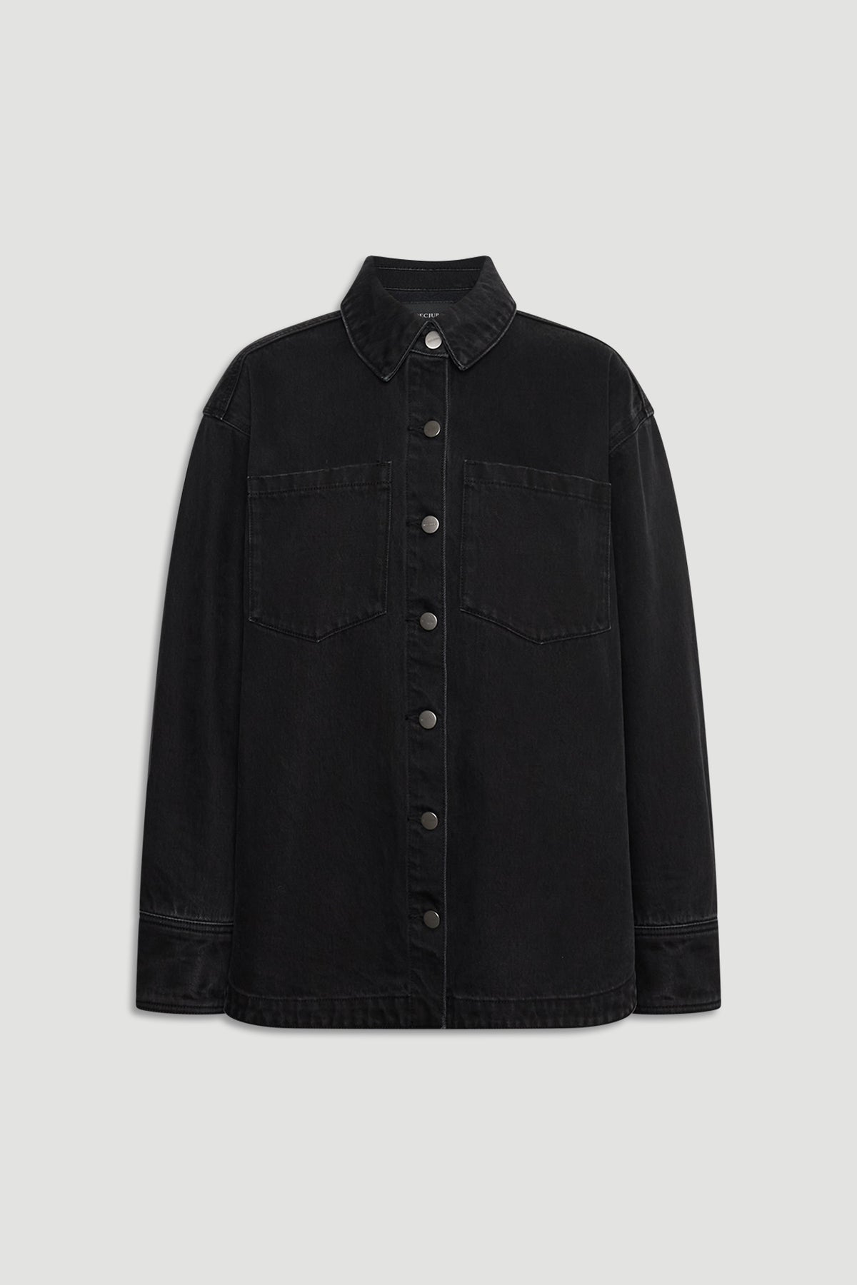 Black denim shirt with front button closure, chest pockets, and classic collar for timeless casual style