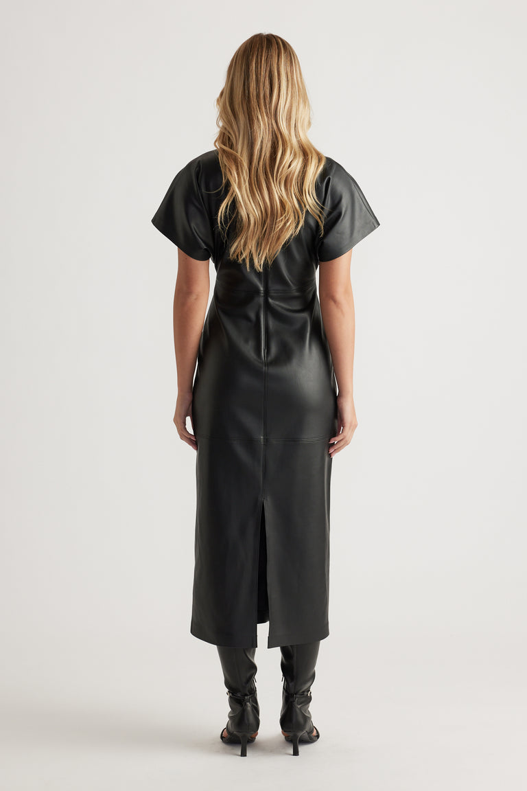 Back view of a fitted black faux leather midi dress with short sleeves and center back seam detailing.