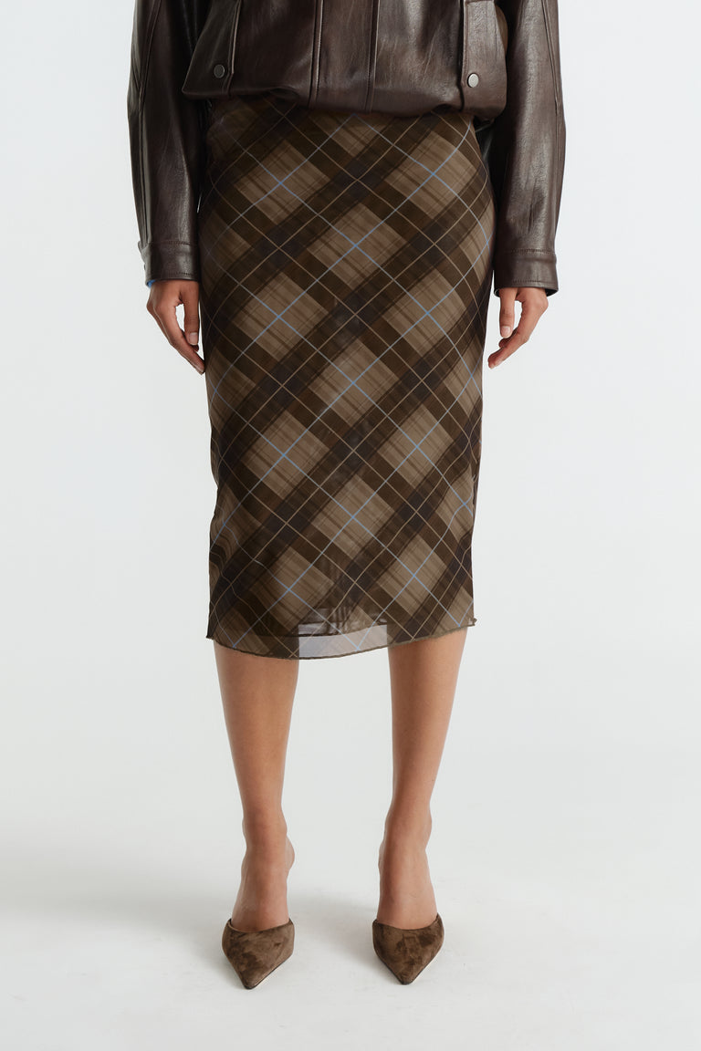 Knee-length mesh skirt in caramel and brown plaid with subtle blue lines, styled with a dark brown leather jacket.
