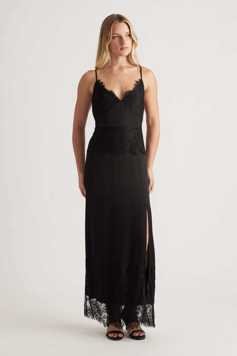 Black maxi dress with lace details, thin straps, a side slit, and a flattering fitted silhouette for evening wear