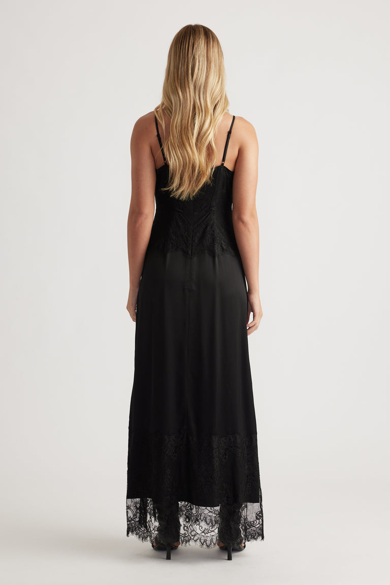 Back view of a black lace maxi dress with delicate lace trim and thin adjustable straps for an elegant silhouette