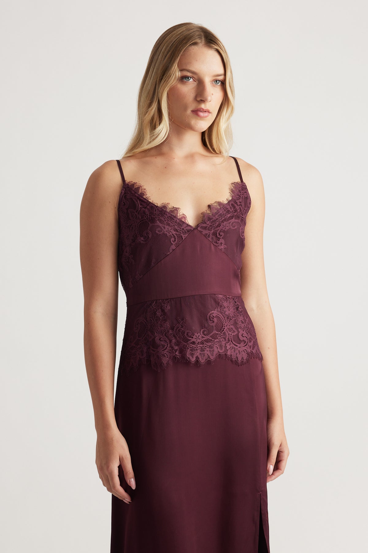 Sleeveless plum maxi dress with delicate lace detailing at the neckline and waist, featuring a slim, elegant fit.