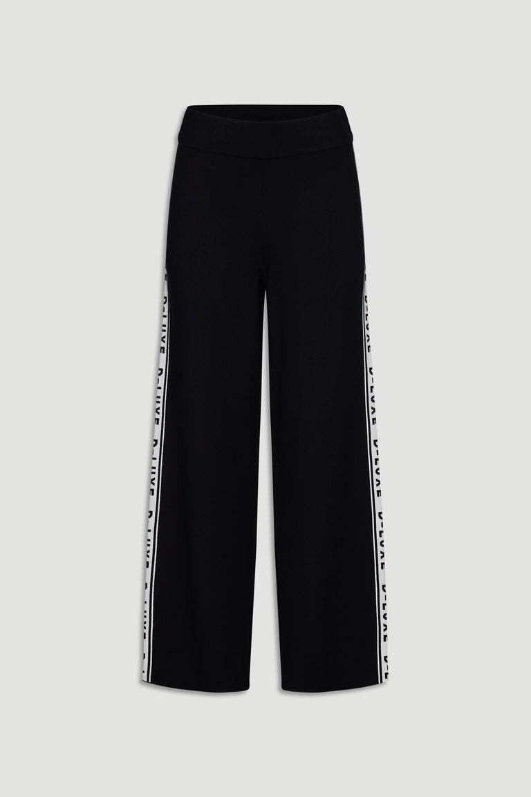 Black wide-leg knit pants featuring contrast logo panels along the side seams for a sporty, modern look.