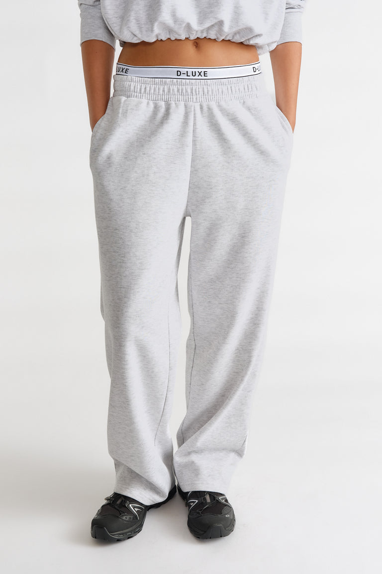 Light grey relaxed-fit track pants with elastic waist featuring a branded D-Luxe logo band for casual comfort.