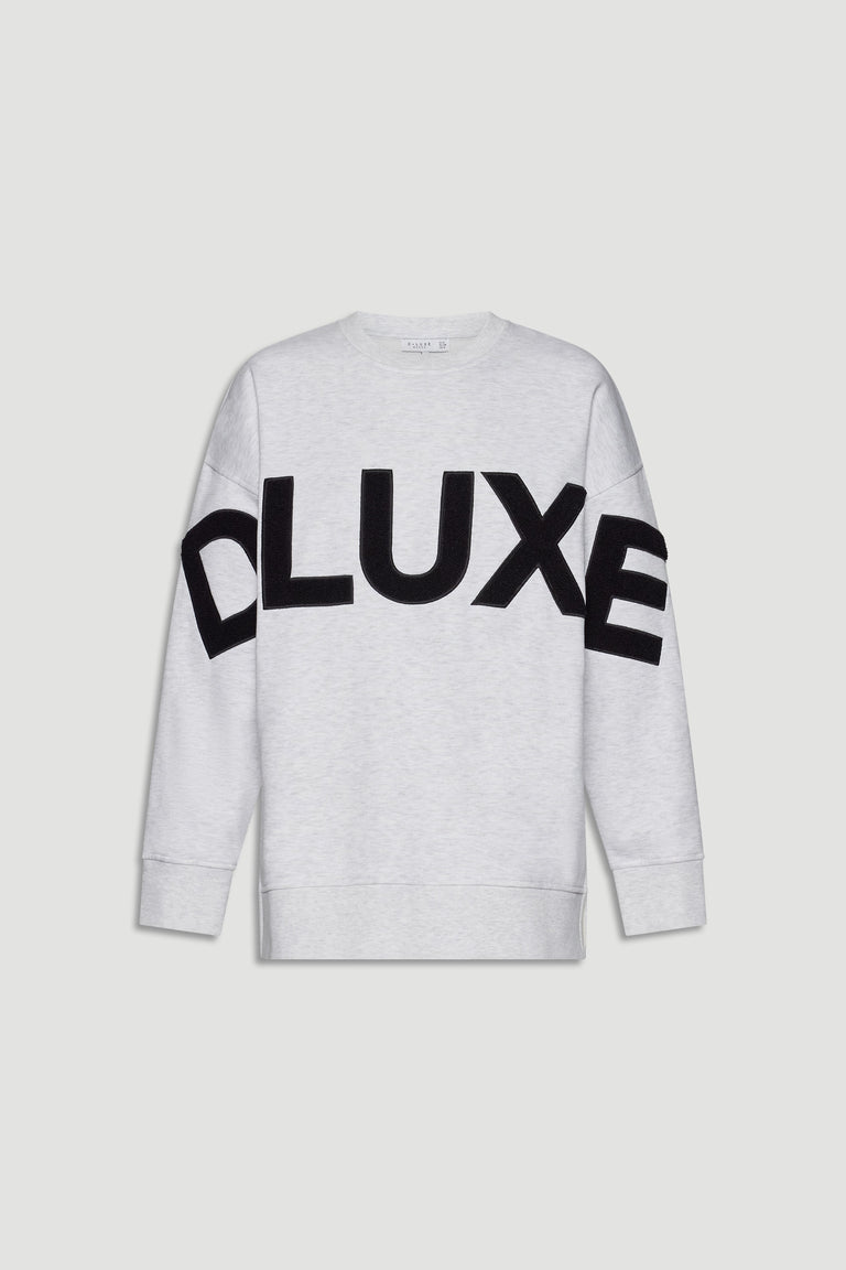 Light grey long-sleeve sweatshirt featuring bold black boucle letters across the chest for a casual, stylish look