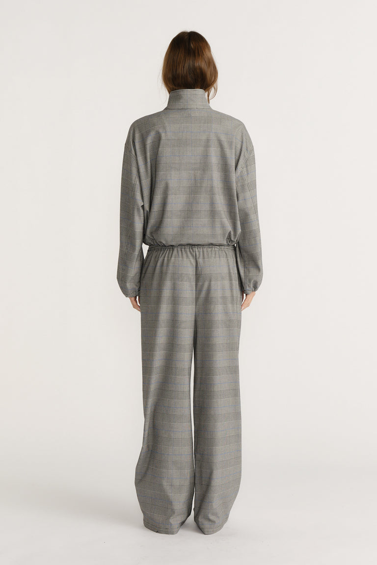 Back view of a relaxed-fit grey checked jacket and matching wide-leg pants set against a neutral background.