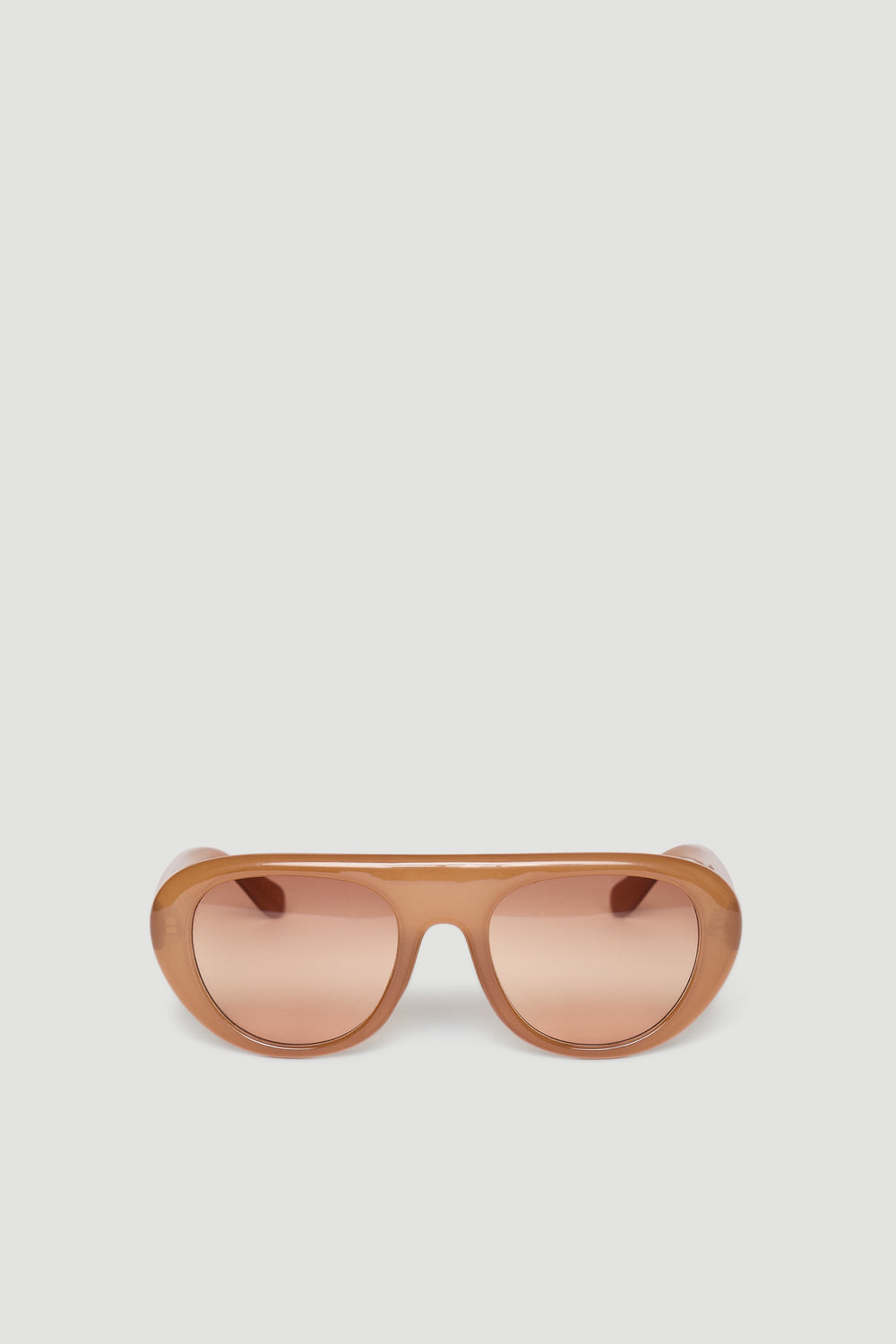 Retro-inspired aviator sunglasses in warm caramel tones with rounded frames and tinted lenses.