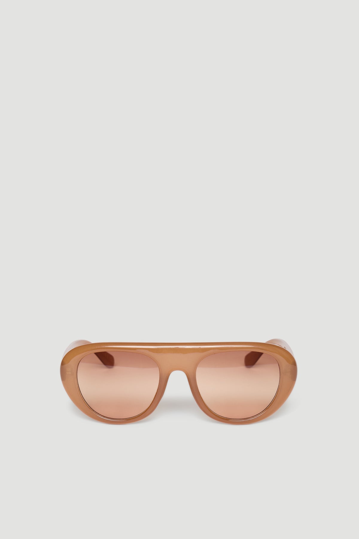 Retro-inspired aviator sunglasses in warm caramel tones with rounded frames and tinted lenses.