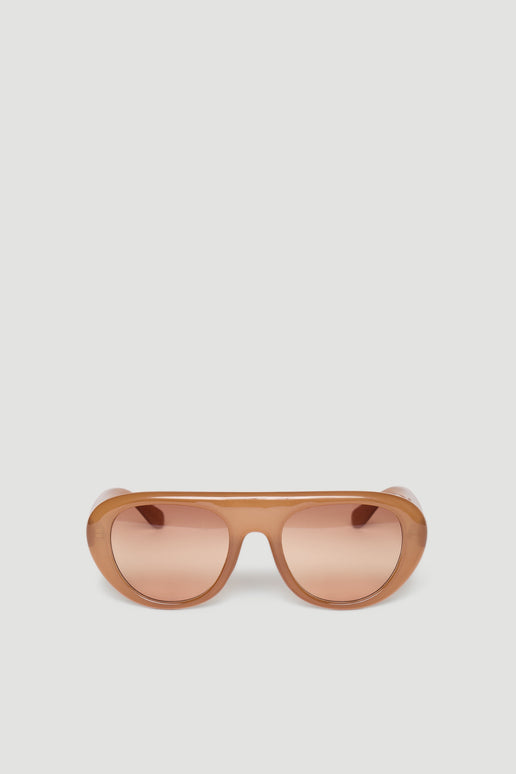 Retro-inspired aviator sunglasses in warm caramel tones with rounded frames and tinted lenses.