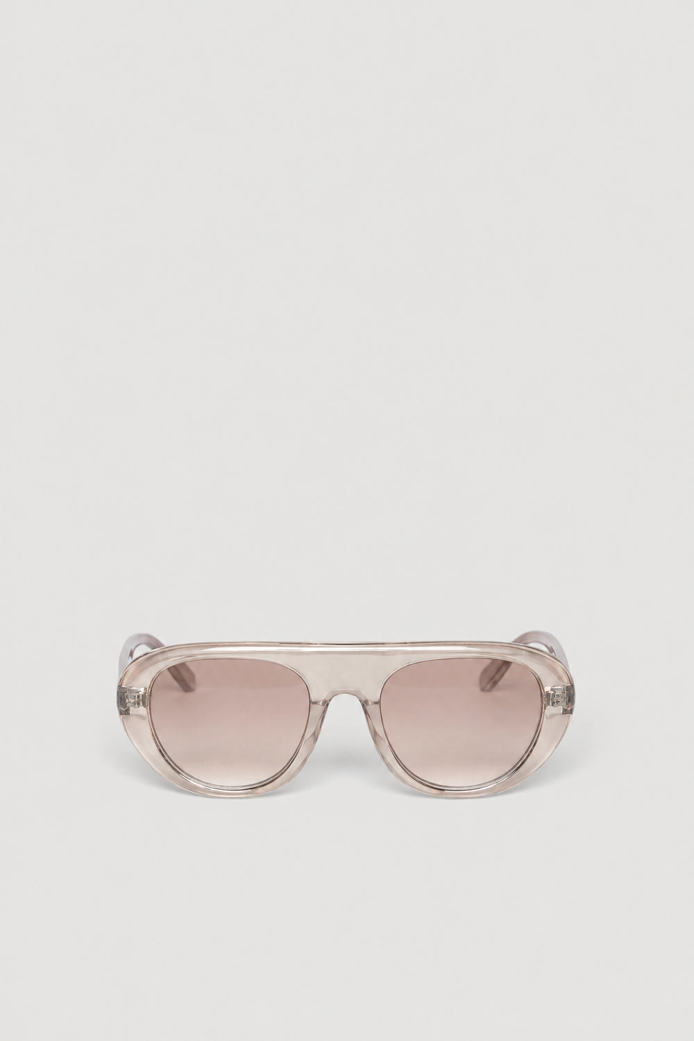 Oversized retro aviator sunglasses with a clear frame and tinted lenses