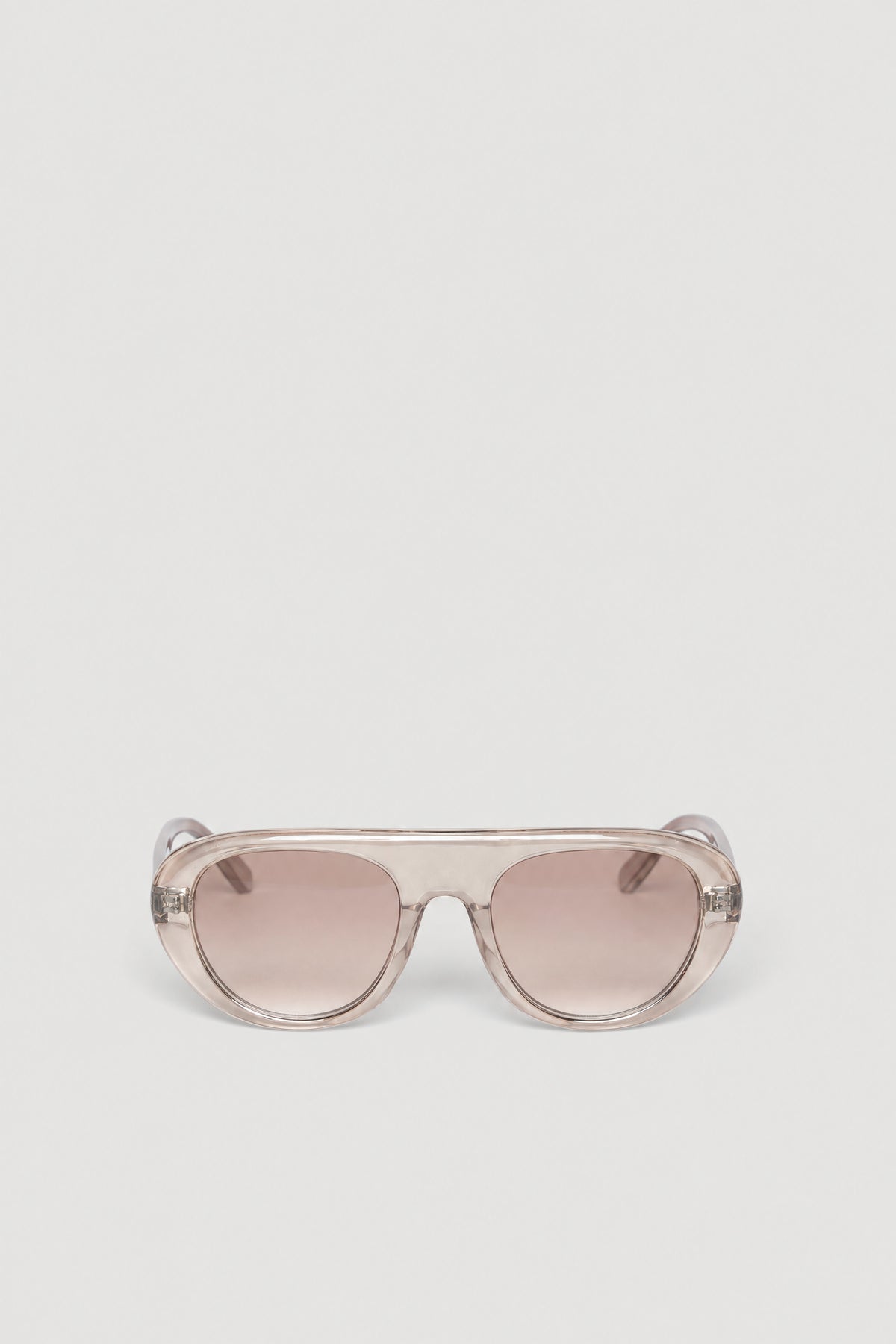 Oversized retro aviator sunglasses with a clear frame and tinted lenses