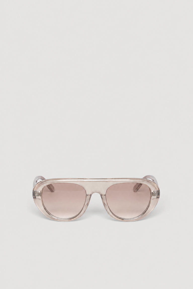 Oversized retro aviator sunglasses with a clear frame and tinted lenses